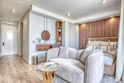 a living room with a couch and a table at The Oud at Ellipse Waterfall in Vosburg