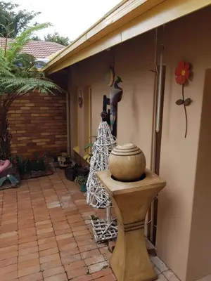a patio with a vase sitting on a table at Sekelbos Guesthouse in Pretoria