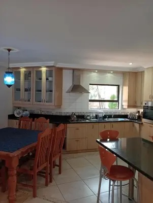 a kitchen with a table and chairs and a dining room at Bekkersheim in Pretoria