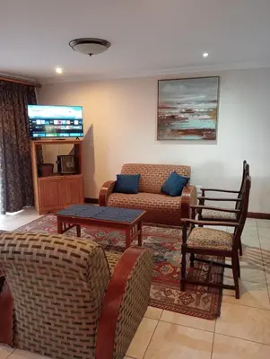 a living room with a couch and chairs at Bekkersheim in Pretoria