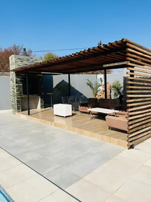 a pavilion with couches and chairs on a patio at Laconda Rosa in Kriel