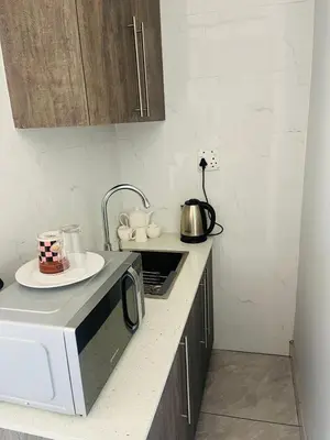 a kitchen with a microwave and a plate on a counter at Laconda Rosa in Kriel