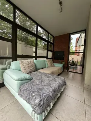 a living room with a couch and a bed at The City Escape in Midrand