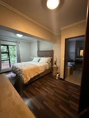 a bedroom with a bed and a large mirror at The City Escape in Midrand