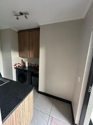 a kitchen with a sink and a counter top at The City Escape in Midrand