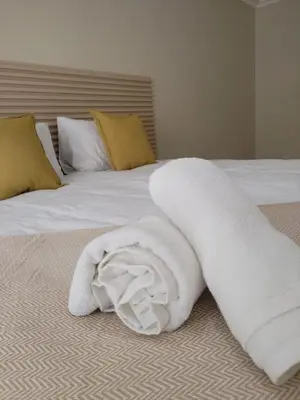 a white towel laying on top of a bed at 33 On Driedoring in Kempton Park