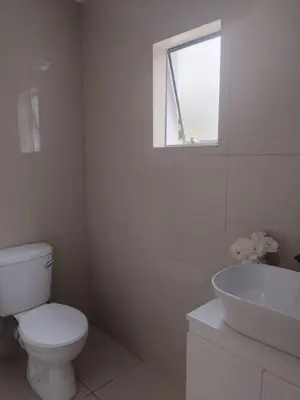 a white bathroom with a toilet and a sink at 33 On Driedoring in Kempton Park