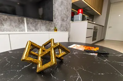 a gold object sitting on top of a table in a kitchen at WanderHaus Haven, Ellipse in Midrand