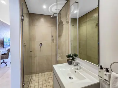 a bathroom with a sink and a shower at Serene Spaces, Ellipse in Midrand