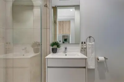 a bathroom with a sink and a shower at Serene Spaces, Ellipse in Midrand