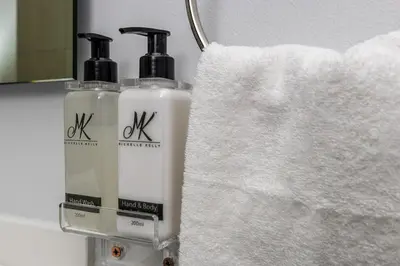two bottles ofodorizers sitting next to a white towel at Serene Spaces, Ellipse in Midrand