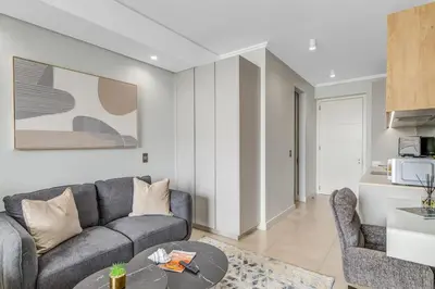 a living room with a couch and a table at Serene Spaces, Ellipse in Midrand