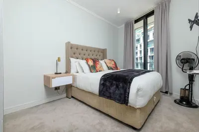 a bedroom with a large bed and a window at Ellips Smartz Apartment in Midrand
