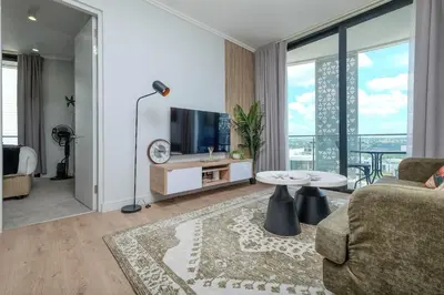 a living room with a couch and a tv at Ellips Smartz Apartment in Midrand