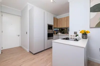 a kitchen with white cabinets and a white counter top at Ellips Smartz Apartment in Midrand