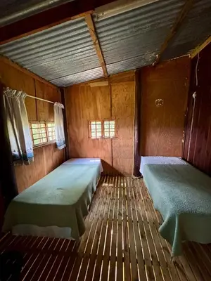 an empty room with two beds in it at Backpackers at Kanaan in Hazyview