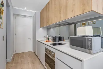 a kitchen with a counter top with a microwave at The Quanta, Ellipse, Watefall in Midrand