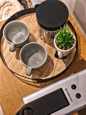 a table with three bowls and a potted plant on it at Menlyn Maine Apartment - 738 at Maine in Pretoria