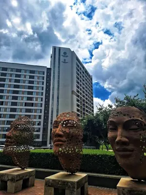 two large head statues in front of a building at Menlyn Maine Apartment - 738 at Maine in Pretoria