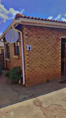 a red brick building with a satellite at Tetelos house in Cullinan