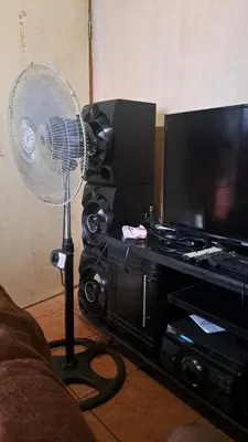 a fan in a living room next to a television at Tetelos house in Cullinan