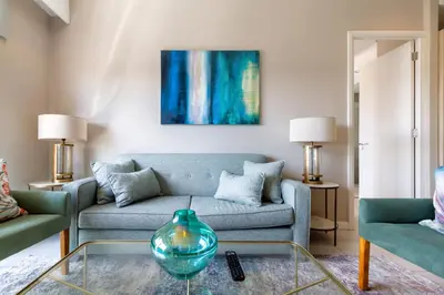 a living room with a couch and a glass table at #AlimamaSpaces Koki's Place Menlyn in Pretoria