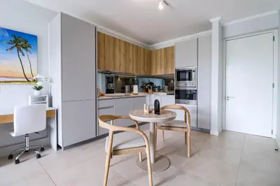 a kitchen with a table and chairs in a room at Waterfall Ellipse-4014 Patimo Opulent Apartment in Midrand