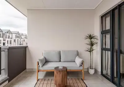 a living room with a couch and a table at Morden Waterfall Escape in Midrand