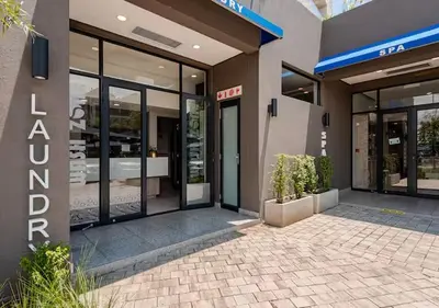a store front of a building with glass doors at Morden Waterfall Escape in Midrand