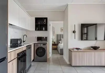 a kitchen with a stove and a dishwasher at Morden Waterfall Escape in Midrand
