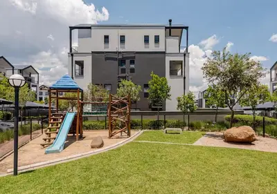 a playground in front of a building with a slide at Morden Waterfall Escape in Midrand