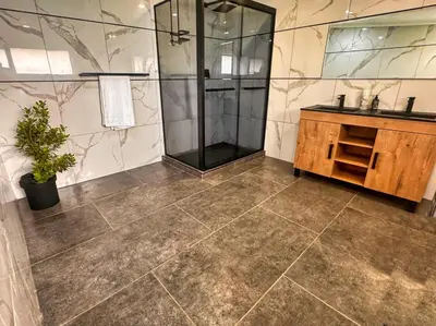 a bathroom with a shower and a sink at Boūs in Graskop