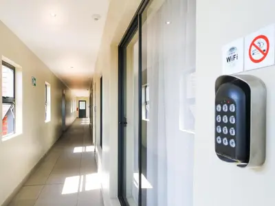 a remote control on a door in a hallway at De Stroom Studio Apartments in Secunda