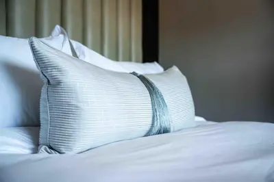 a white pillow sitting on top of a bed at Atimangeni Bush Guest House in Dwarsloop