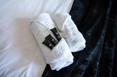 a pair of white socks on a bed at Atimangeni Bush Guest House in Dwarsloop