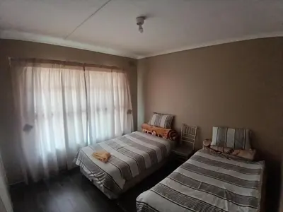 a bedroom with two beds and a window at 12 Bologna B&B in Evander