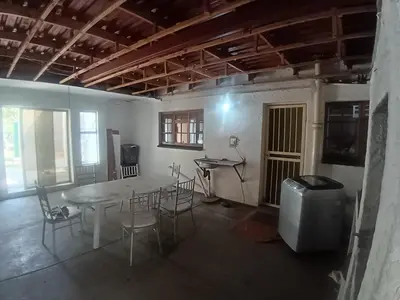 a room with a table and chairs and a television at 12 Bologna B&B in Evander