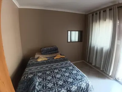 a small bedroom with a bed and a window at 12 Bologna B&B in Evander