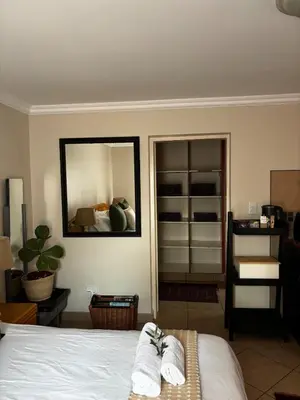 a bedroom with a bed with two towels on it at Olivestay at Olympus - Studio Apartment in Pretoria