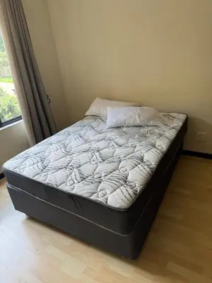 an unmade bed in a bedroom with a window at Madlabeezy in Kempton Park