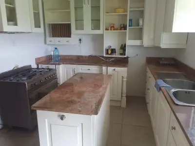 a kitchen with white cabinets and a counter top at Madlabeezy in Kempton Park
