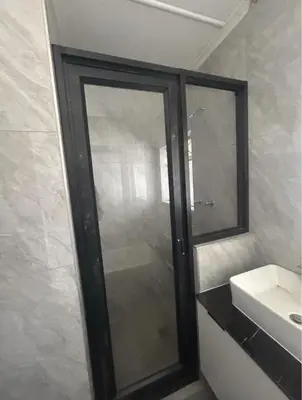 a bathroom with a glass shower and a sink at Madlabeezy in Kempton Park