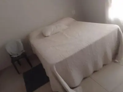 a bedroom with a white bed and a chair at Madlabeezy in Kempton Park