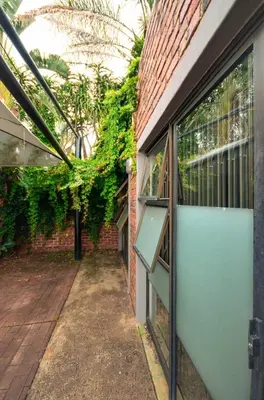 an internal courtyard of a brick building with a blue garage door at Unusual stay in Pretoria