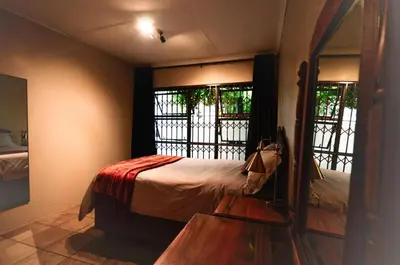 a bedroom with a bed and a window in a room at Unusual stay in Pretoria