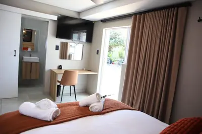 a bedroom with a bed with towels on it at 78onJean in Centurion