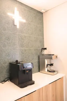 a room with a cash register and a microwave on a counter at 78onJean in Centurion