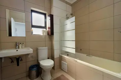 a bathroom with a toilet and a sink and a tub at The View in Fourways