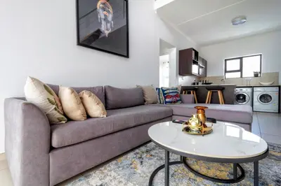 a living room with a couch and a table at The View in Fourways