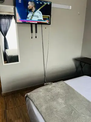 a tv on a wall in a room with a bed at Kasi Retreat in Northam